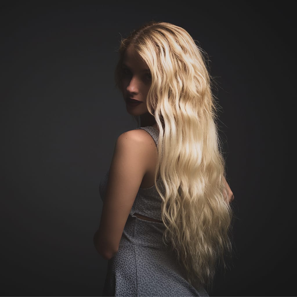 blonde hair extensions waist length hair back view of blonde hair highlight model looking over shoulder