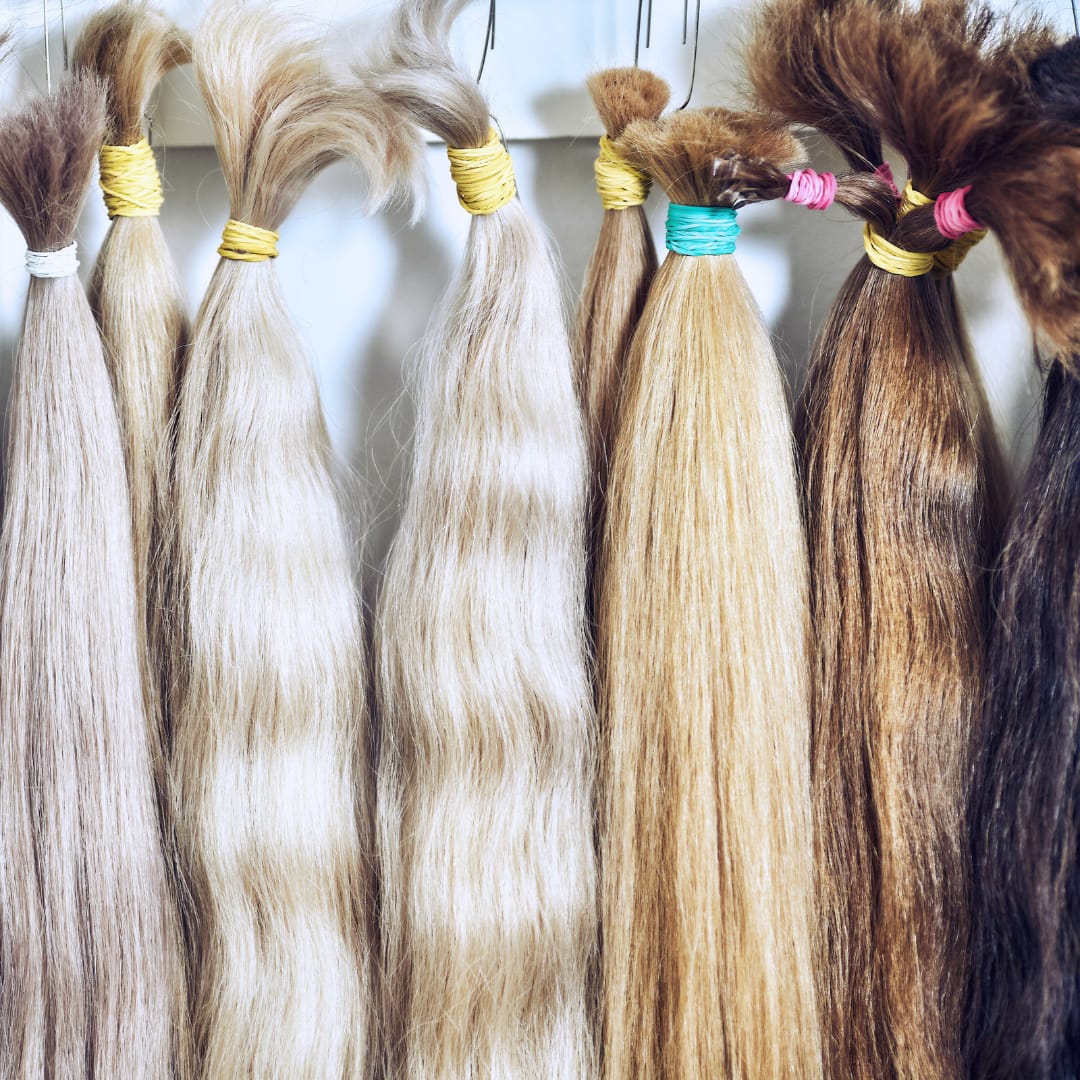 bundles of hair in an assortments of tones before being turned into hand tied weft extensions