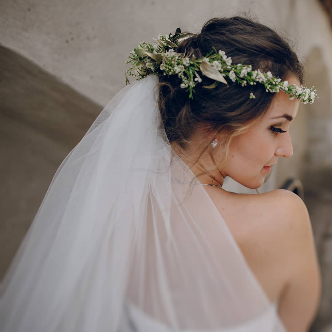 wedding hair updo with loose waves and flower crown