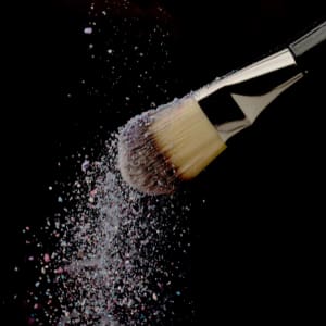 wedding make up artist brush dusting powder off