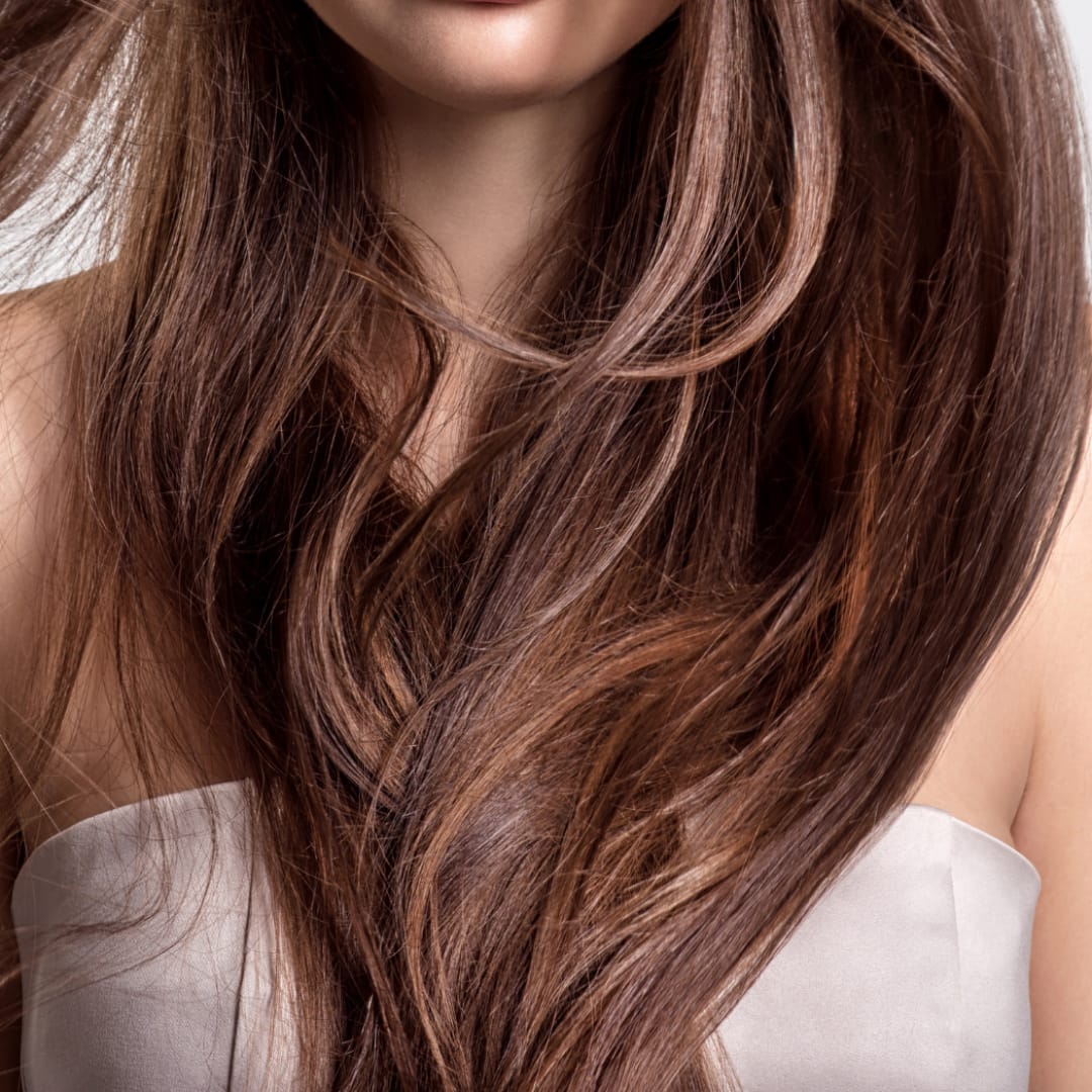 close-up photo of long hand tied weft hair extensions brunette sandy color
